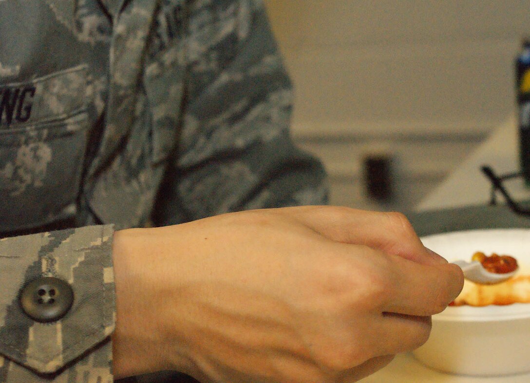 A 914th Logistics Readiness Squadron Airman prepares to taste their chili during the LRS annual chili cook-off.  Airmen of the 914th LRS participate in the event to bolster morale and camaraderie on the unit. (U.S. Air Force photo by Senior Airman Jonathan Perez)