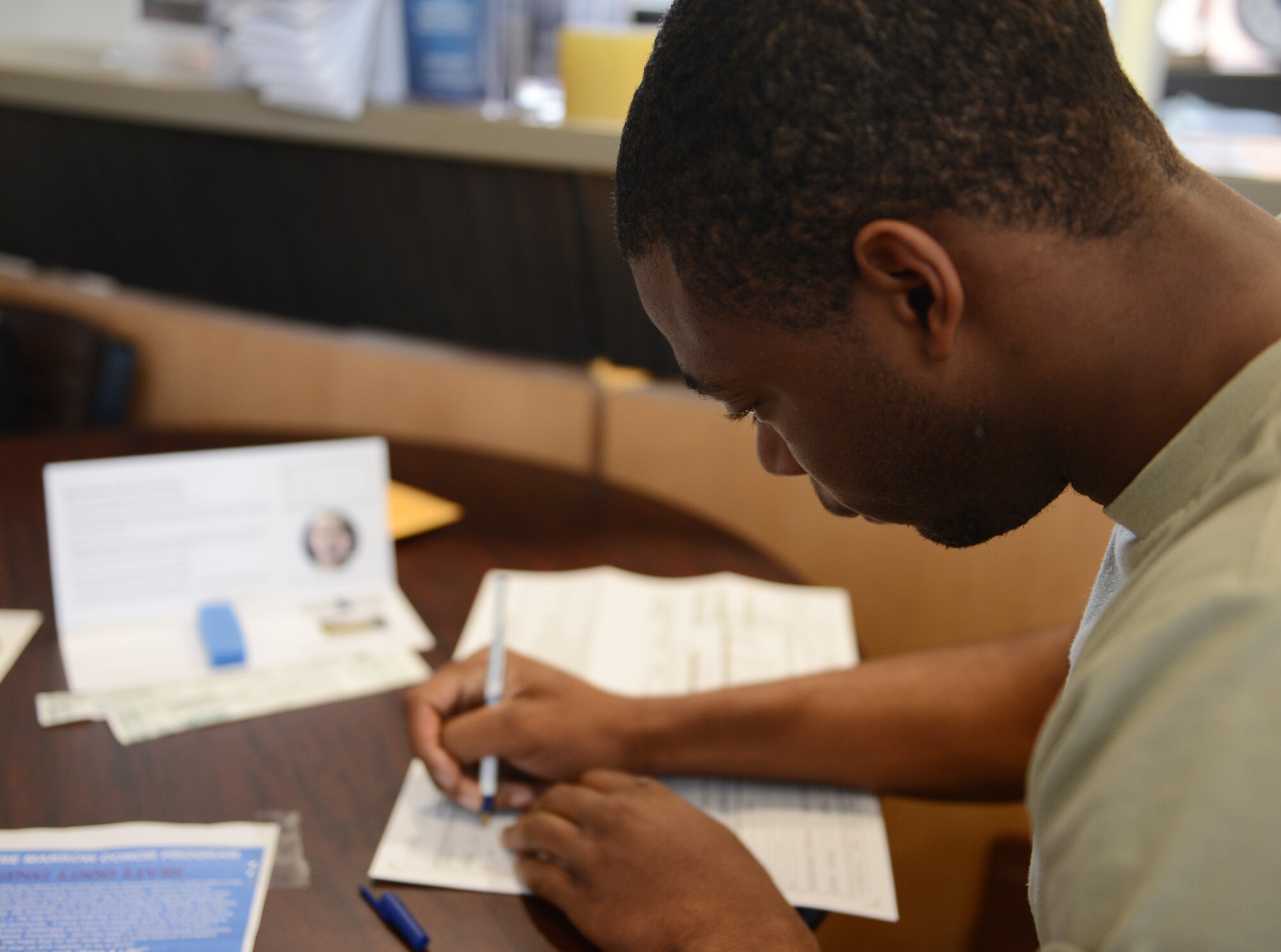 U.S. Air Force Airman 1st Class JT Owens, 20th Aircraft Maintenance Squadron weapons load crew member, registers for the C.W. Bill Young Department of Defense marrow donor program at the fitness center, Shaw Air Force Base, S.C., March 22, 2013. During the week of March 18, 1,195 Team Shaw members registered for the C.W. Bill Young DoD marrow donor program to help save lives of those in need of bone marrow and/or stem cells. (U.S. Air Force photo Senior Airman Tabatha Zarrella/Released)