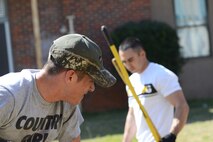 U.S. Air Force Airman 1st Class Jacob Robinson assigned to the 20th Civil Engineer Squadron, rakes weeds from the soil in preparation for a new garden at Hillcrest Middle School, Sumter, S.C., March 19, 2013.  The Airmen volunteered to help plant vegetables for science classes during the spring. (U.S. Air Force photo by Airman 1st Class Nicole Sikorski/Released)