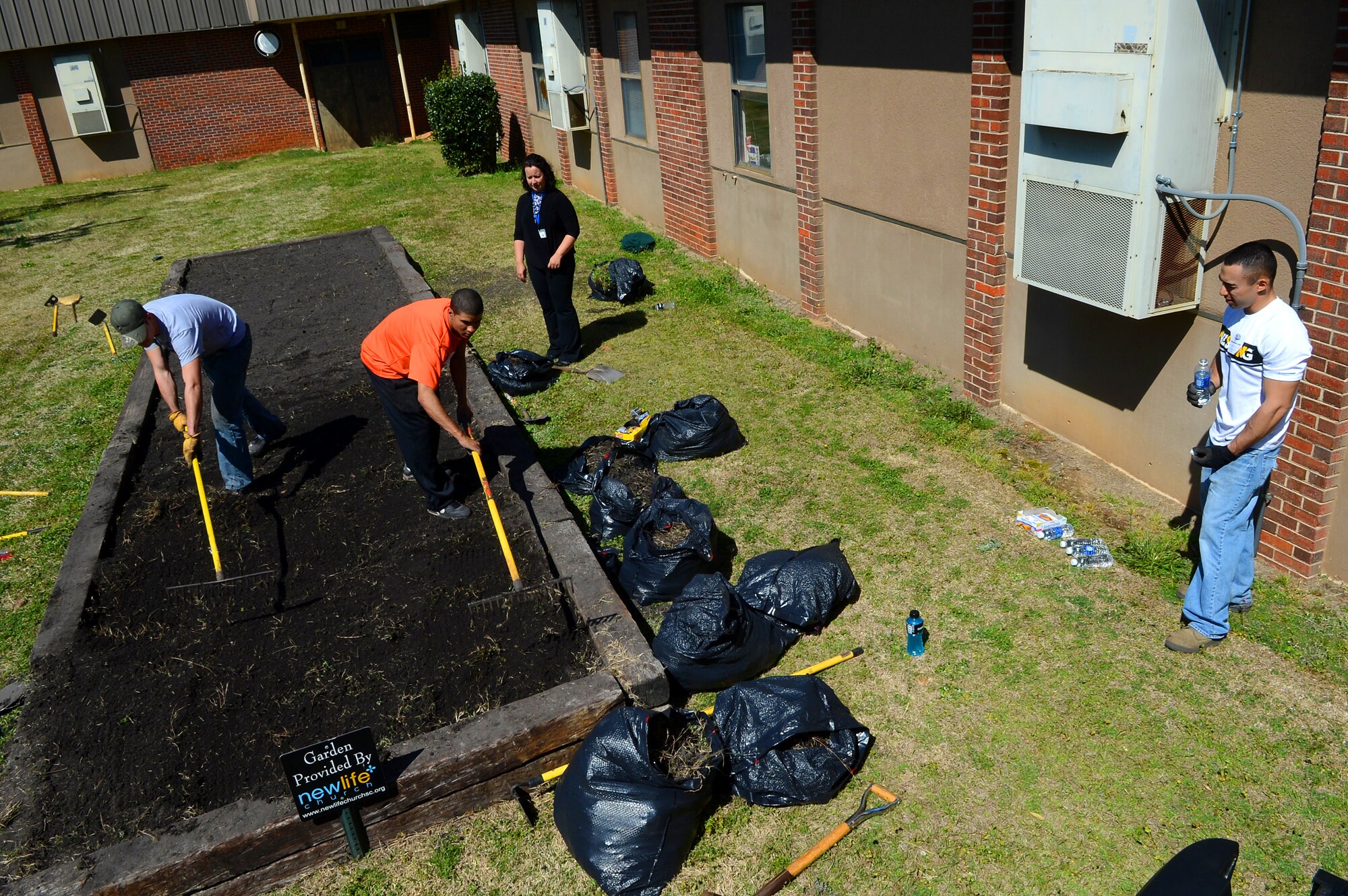 U.S. Air Force Airmen assigned to the 20th Civil Engineer Squadron rake the soil for a garden at Hillcrest Middle School, Sumter, S.C., March 19, 2013.  The Airmen volunteered to help plant vegetables for the study of photosynthesis during the spring. (U.S. Air Force photo by Airman 1st Class Nicole Sikorski/Released)