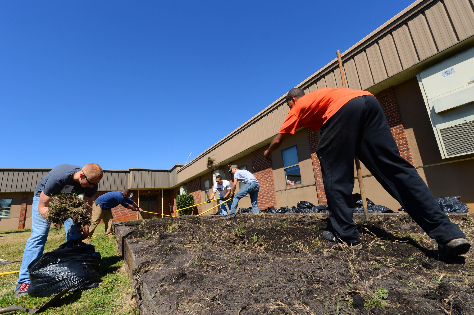 U.S. Air Force Airmen assigned to the 20th Civil Engineer Squadron plant a garden at Hillcrest Middle School, Sumter, S.C., March 19, 2013 The Airmen volunteered to help plant vegetables for the study of photosynthesis during the spring.  (U.S. Air Force photo by Airman 1st Class Nicole Sikorski/Released)
