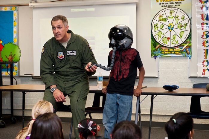 Col. Peter Ford, 57th Adversary Tactics Group commander, explains the use of a pilot’s helmet during career day at Lomie Heard Elementary School March 20, 2013, at Nellis Air Force Base, Nev. Ford spoke about being a pilot, his experiences as a pilot, and the ATG’s mission. (U.S. Air Force photo by Airman 1st Class Jason Couillard)