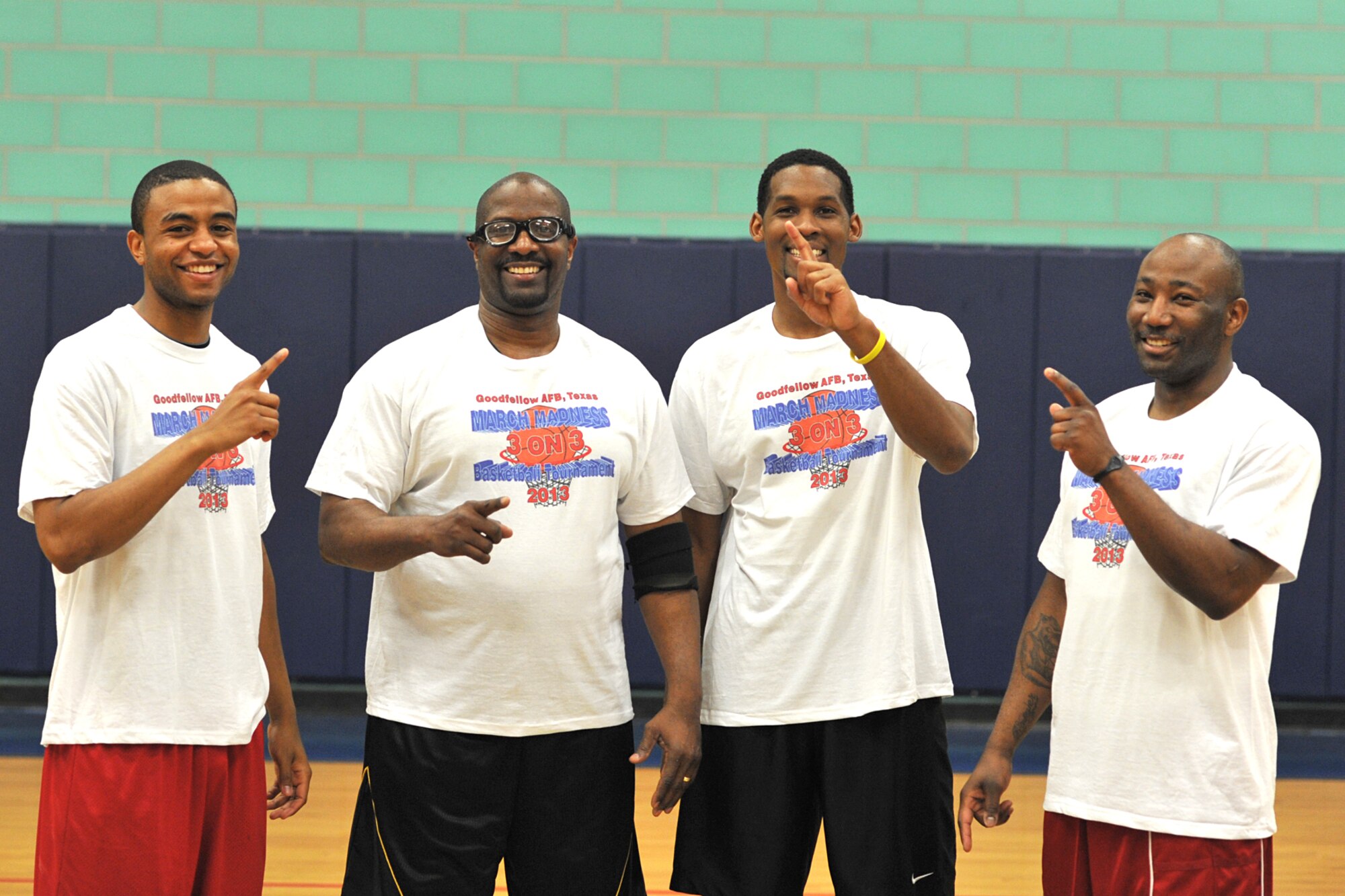 GOODFELLOW AIR FORCE BASE, Texas -- Andre Golden, 17th Training Wing Staff spouse, Sharad White, 17th Communications Squadron, Corey Pasely, 17th Medical Operations Squadron, and Matt Moses, Air Force retired, pose for a photo after winning the 3-on-3 March Madness Basketball Tournament at Mathis Fitness Center, March 22. The 15 teams faced head to head in a double elimination tournament with 15 minutes on the clock to see who would win it all. (U.S. Air Force photo/ Airman 1st Class Michael Smith)