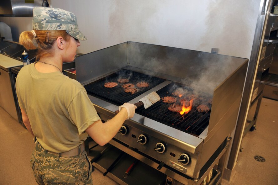Airman 1st Class Stephany Cloutier, 914th Services Squadron, grills some hamburgers in preparation of a Sunday UTA lunch, March 3. With March being Women's History month, it is important that we recognize the contributions of women past and present. A1C Cloutier is one of many women who serve in the United States Armed Forces. (U.S. Air Force photo by Staff Sgt Stephanie Clark) 
