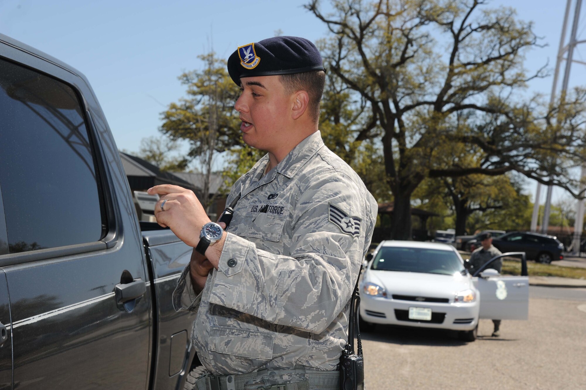 Staff Sgt. Jose Orama, 81st Security Forces Squadron, checks a driver’s credentials while Tech. Sgt. Benjamin Collins, 81st SFS, stands by during a traffic stop March 25, 2013, at Keesler Air Force Base, Miss.  The 81st SFS offers a ride-along program for anyone interested in learning more about Air Force law enforcement.  (U.S. Air Force photo by Kemberly Groue)