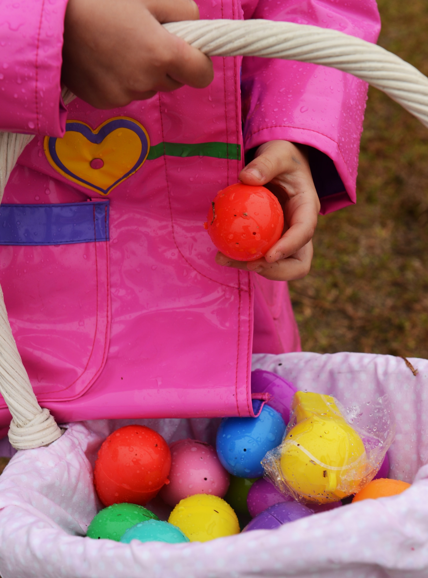 Jesseca Judice, daughter of U.S. Air Force Staff Sgt. Josie Judice, 20th Force Support Squadron services, gathers eggs at the base sports complex, Shaw Air Force Base, S.C., March 23, 2013. As part of the annual Military Child Carnival, sponsored by the Shaw Youth Programs, children of Team Shaw members were invited to participate in an Easter egg hunt. (U.S. Air Force photo by Senior Airman Tabatha Zarrella/Released)
