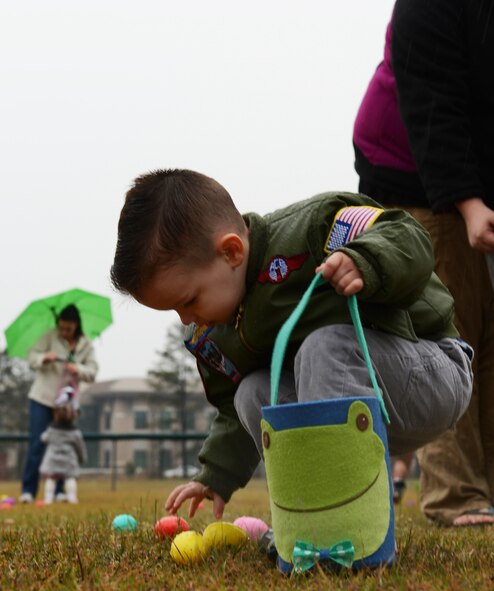 Lucas Dickey, son of U.S. Air Force Staff Sgt. Delbert Dickey, 20th Equipment Maintenance Squadron mobility manager, and Brittany Dickey, gather eggs at the base sports complex, Shaw Air Force Base, S.C., March 23, 2013. As part of the annual Military Child Carnival, sponsored by the Shaw Youth Programs, children of Team Shaw members were invited to participate in an Easter egg hunt. (U.S. Air Force photo by Senior Airman Tabatha Zarrella/Released)