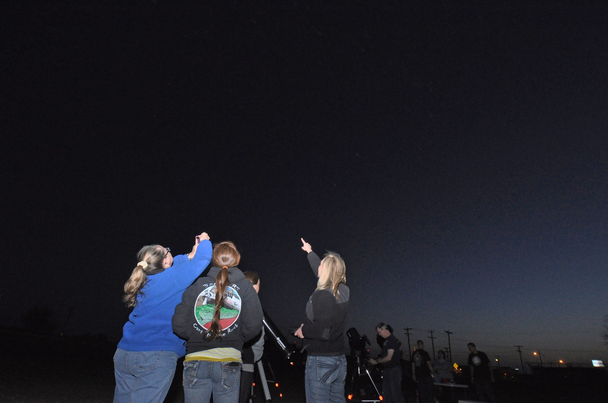 GOODFELLOW AIR FORCE BASE, Texas—Team Goodfellow members use telescopes to look at various celestial bodies during the Stargazer Party at the Youth Softball Field March 23. Food and drinks were served while groups took turns looking at the moon, Jupiter and its moons and a nebula in the Orion constellation. (U.S. Air Force photo/Airman Jessica Keith)