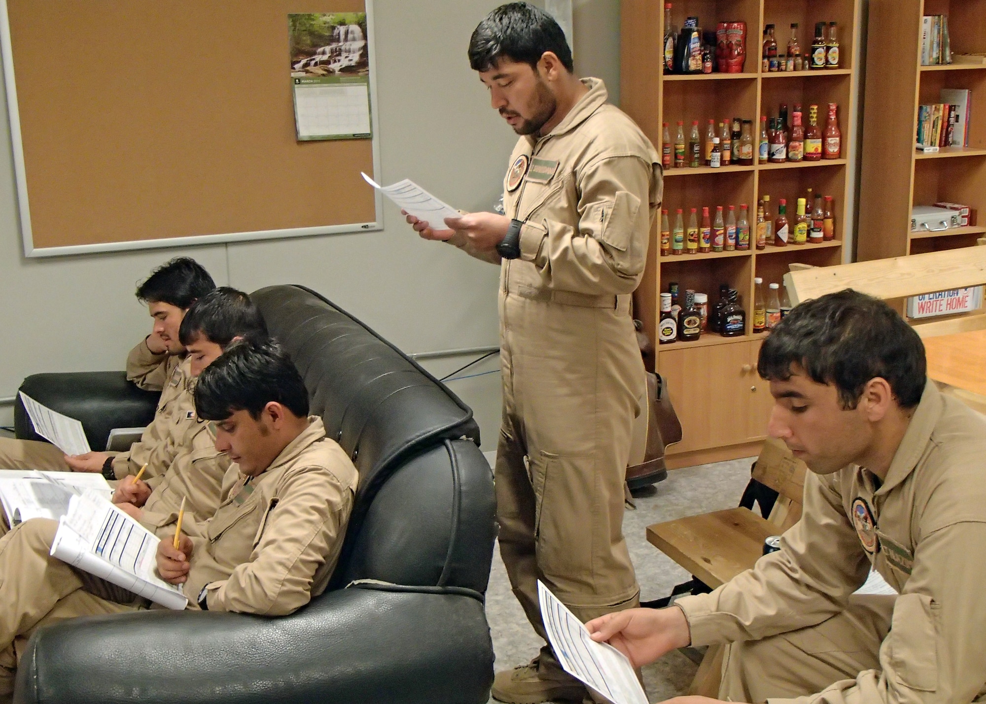 Afghan Air Force pilot trainees conduct a pre-flight briefing prior to a night vision goggle training mission at Shindand Air Base, Afghanistan March 19, 2013. The current class going through NVG training, with eight students, is the largest class as well as only the third class to go through the training at SAB. NVG training is taught by air advisors from the 444th Air Expeditionary Advisory Squadron. (U.S. Air Force photo/Capt. Anastasia Wasem)