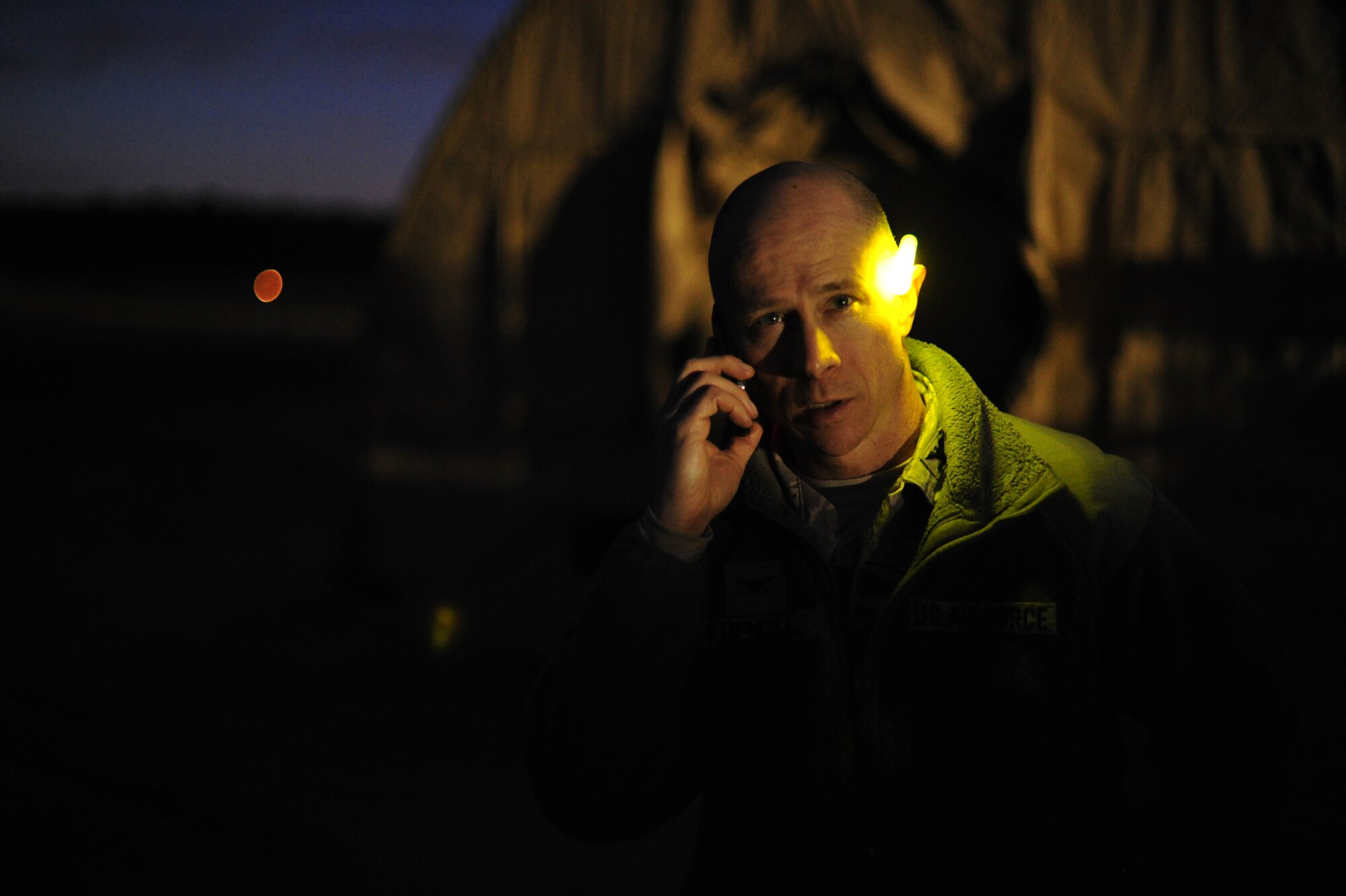 JOINT BASE MCGUIRE-DIX-LAKEHURST, N.J. -- U.S. Air Force Col. David Kuenzli, 817th Contingency Response Group commander, talks on a cell phone at Lakehurst during U.S. Transportation Command Joint Task Force Validation exercise Eagle Flag 13-2 March 19, 2013. Kuenzli, 100 Airmen from the 817 CRG and 50 U.S. Army Soldiers from the 690th Rapid Port Element, based at Joint Base Langley-Eustis, Va., were simulating the establishment of an aerial port of debarkation in a fictional country. (U.S. Air Force photo by Tech. Sgt. Parker Gyokeres/Released)