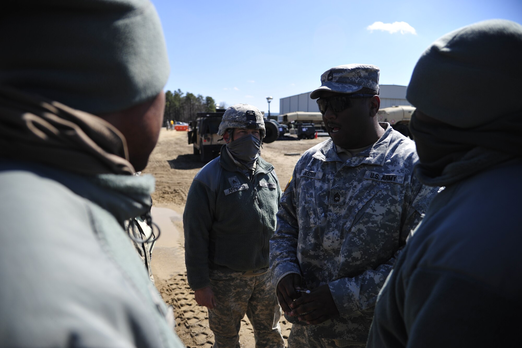 JOINT BASE MCGUIRE-DIX-LAKEHURST, N.J. -- U.S. Army Sgt 1st Class Conteras Jester, operations NCOIC for the 690th Rapid Port Opening Element based at Joint Base Langley-Eustis, Va., speaks with surface distribution drivers during an operational pause at Lakehurst March 20, 2013. The 690th RPOE was deployed alongside the 621st Contingency Response Wing at JBMDL for a U.S. Transportation Command Joint Task Force Validation exercise Eagle Flag 13-2. (U.S. Air Force photo by Tech. Sgt. Parker Gyokeres/Released)