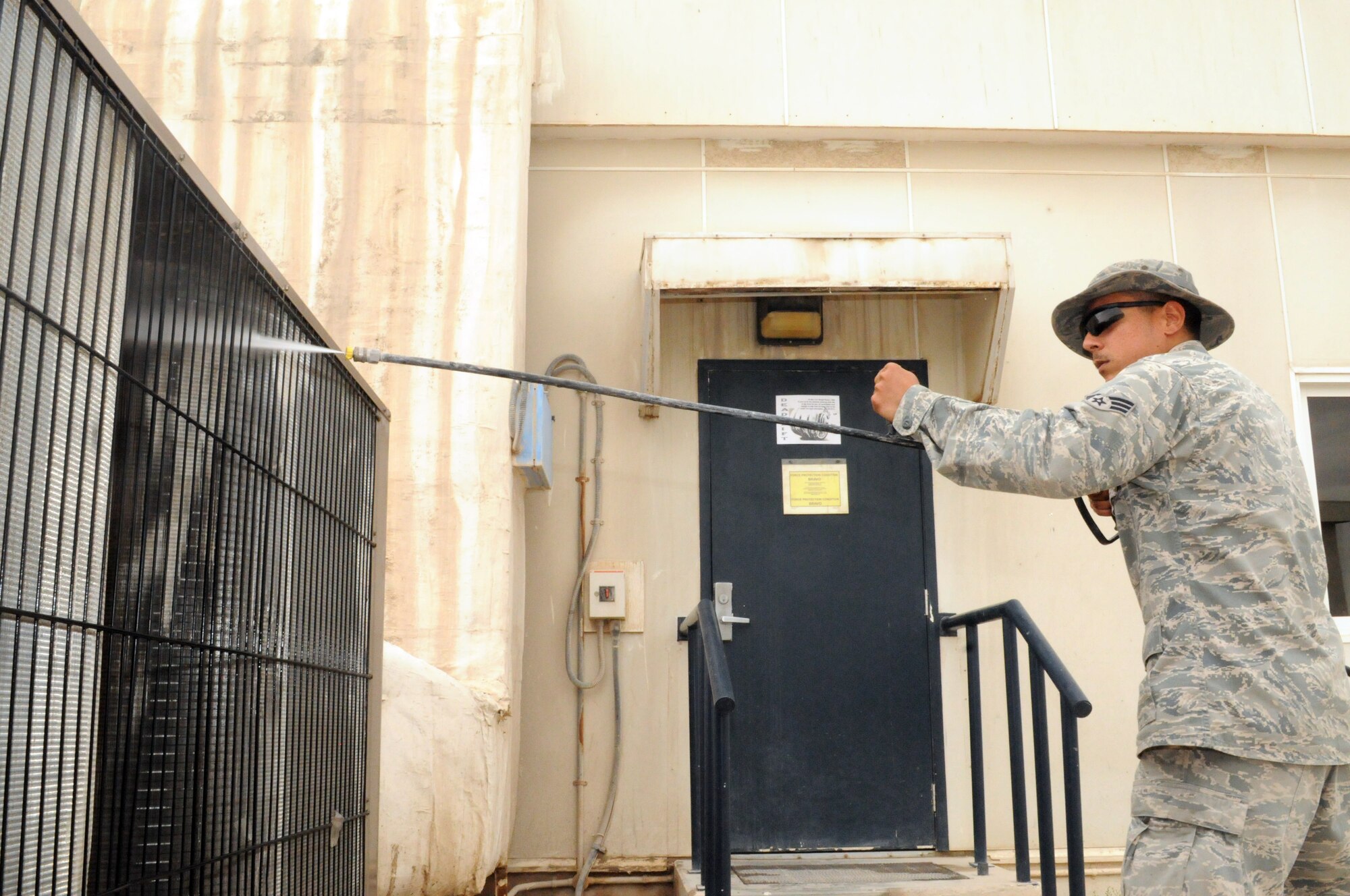 SOUTHWEST ASIA -- Senior Airman Dick Rodriguez performs preventative maintenance on the Coalition Compound weight room air conditioner, March 21. The 379th Expeditionary Civil Engineer Squadron Heating Ventilation Air Conditioning / Refrigeration shop maintains all wing and tenant HVAC/R systems on base. (U.S. Air Force photo/Master Sgt. Christian Michael)