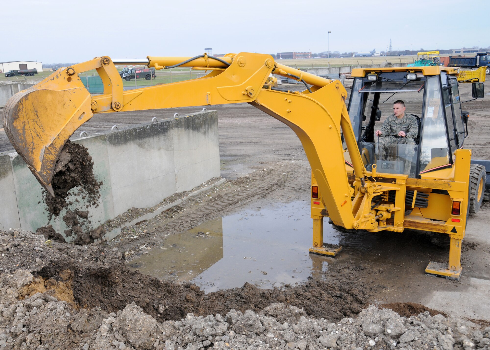 Airman 1st Class Stephen Beasley, 100th Civil Engineer Squadron Pavements and Construction equipment operator "Dirt boy" from Wake Forest, N.C., uses a backhoe to stock-pile fill material for future use March 21, 2013, at RAF Mildenhall, England. Backhoes are a multi-purpose piece of equipment used for excavation operations on base. The term “Dirt boyz” is a slang term used among those in RED HORSE. It is similar to a term of endearment-one that is said with respect, admiration and distinction throughout the civil engineer career field. (U.S. Air Force photo by Gina Randall/Released)