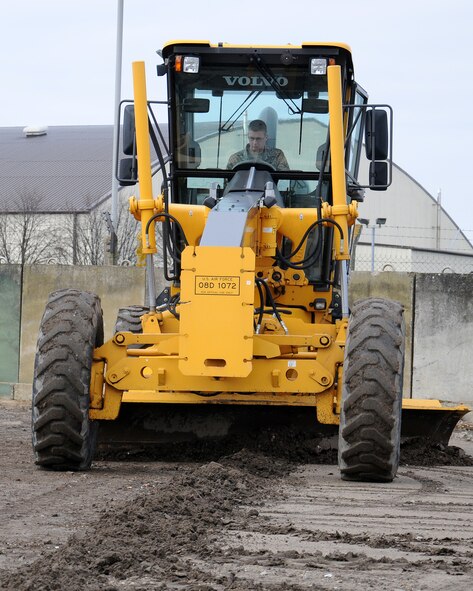Senior Airman Joshua Walters, 100th Civil Engineer Squadron Pavements and Construction equipment operator "Dirt boy" from Berlin, Pa., uses a grader to level the area and improve driving conditions, March 21, 2013, at RAF Mildenhall, England. Graders are used to level areas and to build roads. They are also used for snow removal and to make roads and surfaces safe for users. The term “Dirt boyz” is a slang term used among those in RED HORSE. It is similar to a term of endearment-one that is said with respect, admiration and distinction throughout the civil engineer career field. (U.S. Air Force photo by Gina Randall/Released)