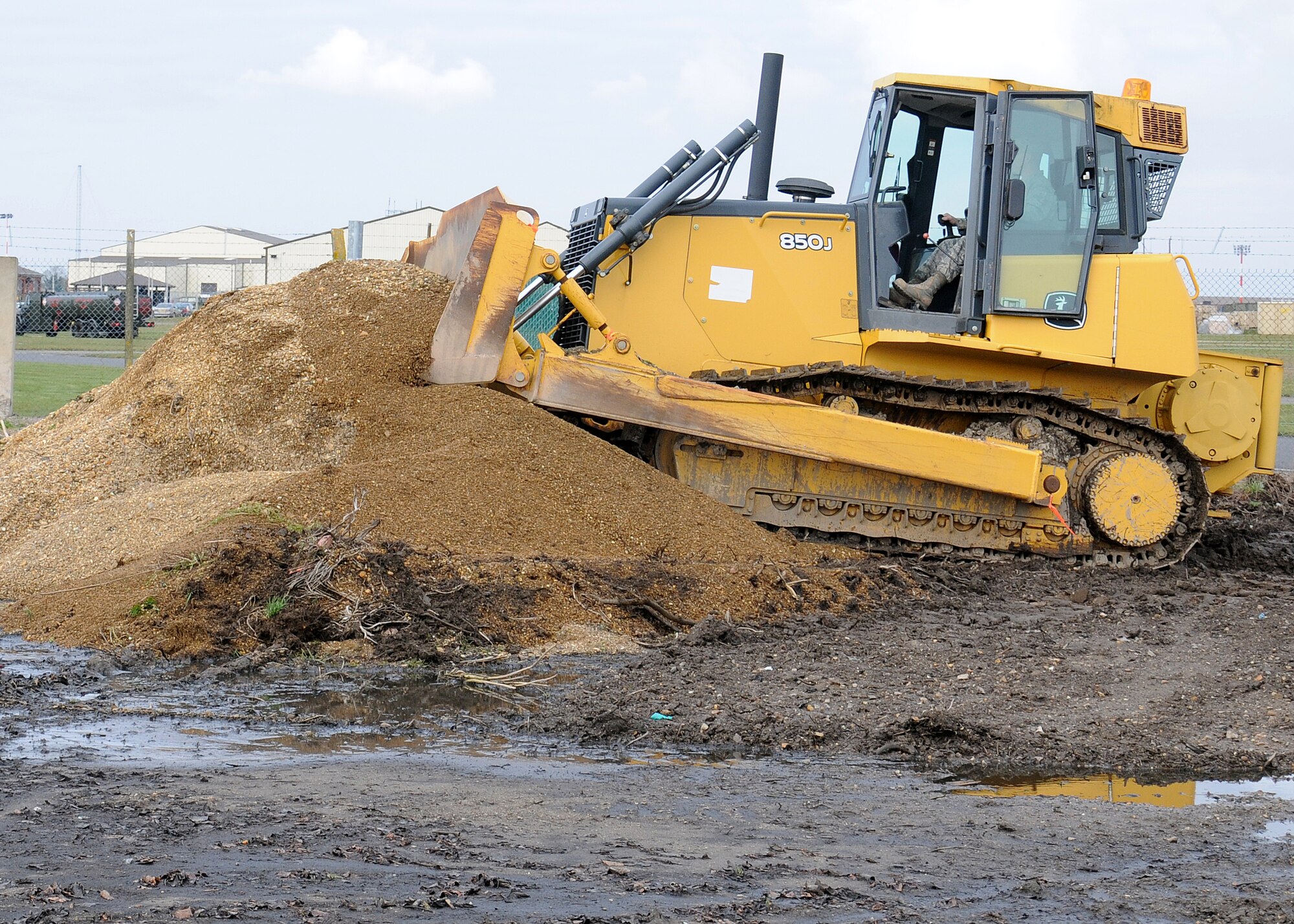 Staff Sgt. Tyler Meiers, 100th Civil Engineer Squadron Pavements and Construction equipment operator "Dirt boy" from Armour, S.D., uses a dozer to stock-pile gravel March 21, 2013, at RAF Mildenhall, England. Dozers are used to move large amounts of material, stock-pilling and for heavy construction. The term “Dirt boyz” is a slang term used among those in RED HORSE. It is similar to a term of endearment-one that is said with respect, admiration and distinction throughout the civil engineer career field. (U.S. Air Force photo by Gina Randall/Released)