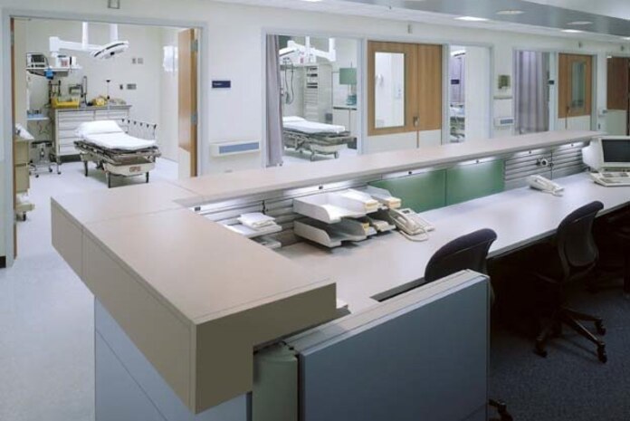 This photo shows a modern, modular nurses' station with several other Integrated Medical Furniture Program clinical products in the treatment rooms.