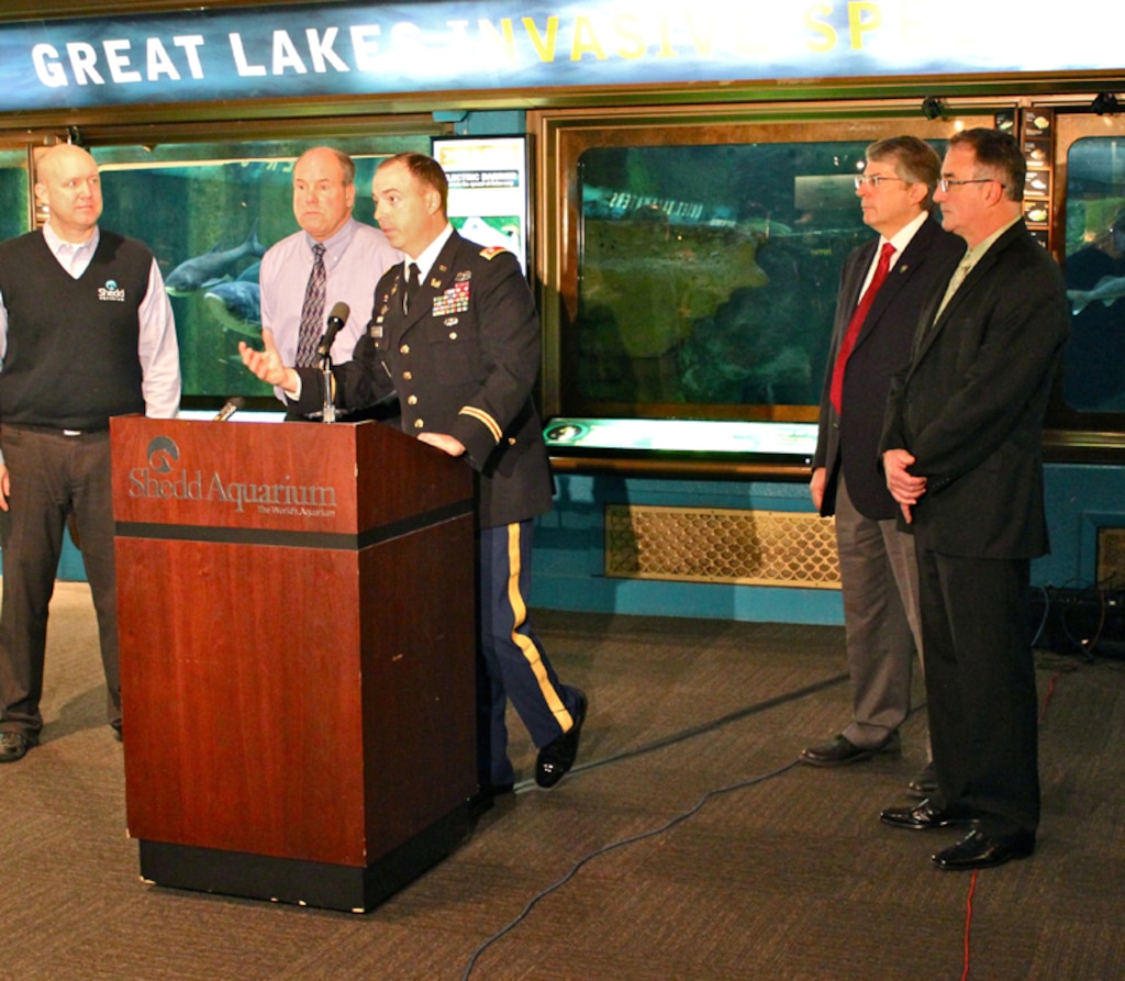 Chicago District Deputy Commander Lt. Col. Jim Schreiner answers media questions at press conference to introduce three new bighead carp to the Invasive Species Exhibit at the Shedd Aquarium, Chicago, Ill., Dec. 20, 2012. 

In back, from left, Shedd Aquarium Executive Vice President of Great Lakes and Sustainability Roger Germann, U.S. Fish and Wildlife Service Midwest Deputy Regional Director Charlie Wooley, Illinois Department of Natural Resources Assistant Director John Rogner and U.S. Environmental Protection Agency Senior Advisor Bill Bolen.
