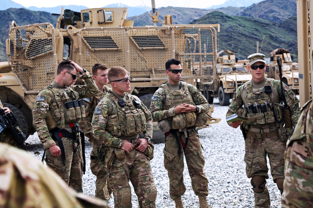 U.S. Army 2nd Lt. George Hayworth, right, conducts a pre-mission brief ...