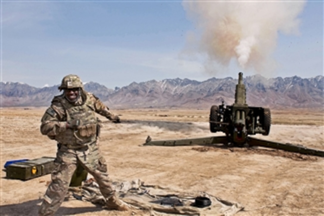 U.S. Army Sgt. 1st Class Fredrick Edwards yanks a lanyard to test fire a D-30 howitzer at the Kabul Military Training Center in Afghanistan on March 19, 2013.  The test fire is the final step before reissue of this refurbished artillery weapon.  