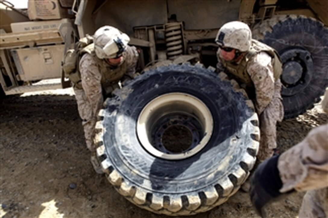 U.S. Marines change a tire during a combat logistics patrol to Forward Operating Base Payne in the Helmand province of Afghanistan on March 23, 2013.  Marines with Rolling Thunder 1, Transportation Support Company, Combat Logistics Regiment 2 conducted the patrol to facilitate the demilitarization of the base.  