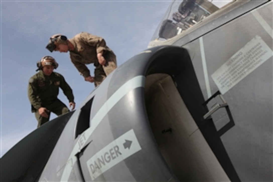 U.S. Marine Corps Cpls. Asiel A. Perez (left) and Blake R. Phillips perform maintenance on AV-8B Harrier II aircraft on the flight line at Camp Leatherneck, Helmand Province, Afghanistan, on March 5, 2013.  Perez and Phillips, attached to Marine Attack Squadron 231, are working on the aircraft as part of their daily turnaround inspections.  