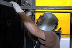 A Texas National Guard Soldier, who is not being identified for security reasons, welds a gun cage for the Border Patrol at the Laredo North Station in the Laredo Sector. The Soldier, a Hurricane Katrina refugee who made a new home in Texas, volunteered to serve in Operation Jump Start for a year. The National Guard is helping the Border Patrol secure the U.S. border with Mexico.