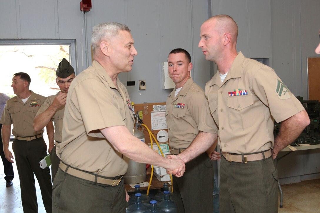 The Assistant Commandant of the Marine Corps, Gen. John M. Paxton, Jr., visits with Marines and Sailors from Third Marines Division, U.S. Marine Corps base Hawaii, March 8, 2013. The trip is part of a larger West Pacific trip. (U.S. Marine Corps photo by Cpl. Tia Dufour/Released)