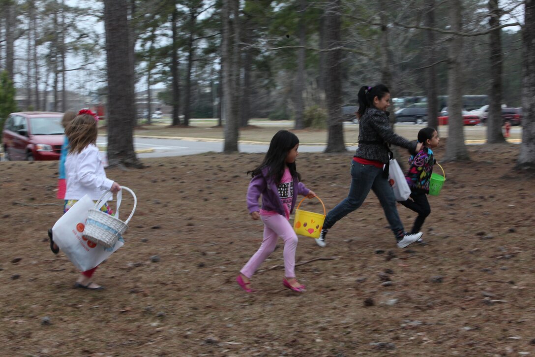 Children of Marines with Combat Logistics Battalion 6, 2nd Marine Logistics Group run in search of Easter eggs during a family event aboard Camp Lejeune, N.C., March 23, 2013. The  family readiness officer for the battalion planned the event to help families create a support network in preparation for an upcoming deployment. 
