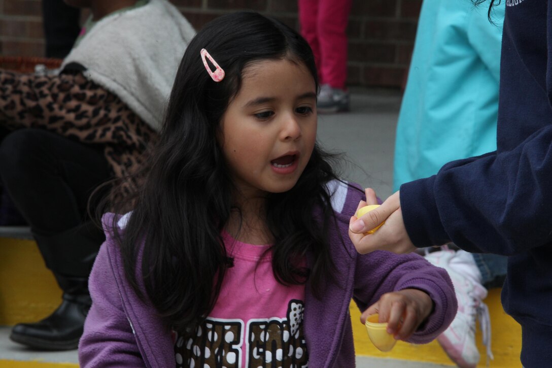 The daughter of a Marine with Combat Logistics Battalion 6, 2nd Marine Logistics Group looks excitedly at the prize in one of the eggs found during an Easter egg hunt aboard Camp Lejeune, N.C., March 23, 2013. The family readiness officer for CLB-6 helped plan the event to build connections between the families in preparation for the battalion’s upcoming deployment. 