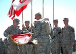 Col. Vernon A. Sevier Jr. (left), of Houston, commander of the 36th CAB, and Command Sgt. Maj. Bradley Brandt (right) of Round Rock, Texas, case the brigade's colors for deployment to Iraq during an official send-off ceremony at the Leo Buckley Stadium in Killeen, Texas, July 30.