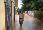 A Texas National Guard Soldier helps a resident of Vinton, Texas, with some belongings after rising water swamped homes in the small west Texas town.