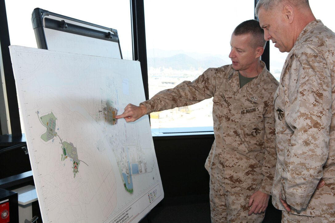 The Assistant Commandant of the Marine Corps, Gen. John M. Paxton, Jr., spaks with Col. James Stewart while on a base tour of Marine Corps Air Station Iwakuni, Japan, March 11, 2013. The tour was hosted by Col. James Stewart. (U.S. Marine Corps photo by Cpl. Tia Dufour/Released)