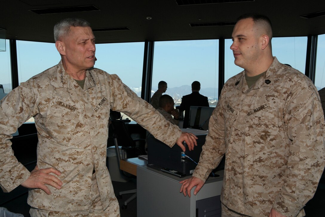 The Assistant Commandant of the Marine Corps, Gen. John M. Paxton, Jr., visits with Marines while on a base tour of Marine Corps Air Station Iwakuni, Japan, March 11, 2013. The tour was hosted by Col. James Stewart. (U.S. Marine Corps photo by Cpl. Tia Dufour/Released)