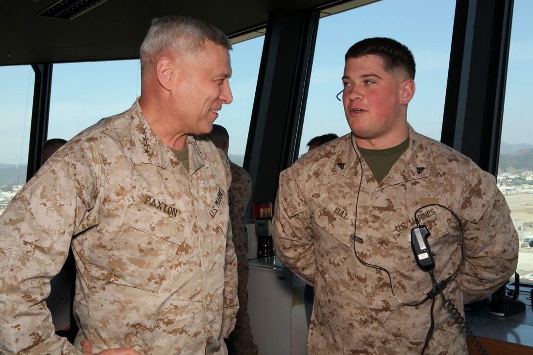 The Assistant Commandant of the Marine Corps, Gen. John M. Paxton, Jr., visits with Marines while on a base tour of Marine Corps Air Station Iwakuni, Japan, March 11, 2013. The tour was hosted by Col. James Stewart. (U.S. Marine Corps photo by Cpl. Tia Dufour/Released)