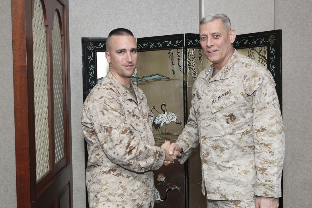 The Assistant Commandant of the Marine Corps, Gen. John M. Paxton, Jr., visits with Marines while on a base tour of Marine Corps Air Station Iwakuni, Japan, March 11, 2013. The tour was hosted by Col. James Stewart. (U.S. Marine Corps photo by Cpl. Tia Dufour/Released)