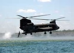 A Soldier of the Texas Army National Guard's 143rd Long Range Surveillance Detachment, 36th Infantry Division, jumps into Lake Walter E. Long from a Republic of Singapore Air Force CH-47 Chinook helicopter during a hurricane preparedness training exercise in central Texas.