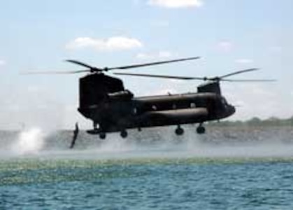 A Soldier of the Texas Army National Guard's 143rd Long Range Surveillance Detachment, 36th Infantry Division, jumps into Lake Walter E. Long from a Republic of Singapore Air Force CH-47 Chinook helicopter during a hurricane preparedness training exercise in central Texas.