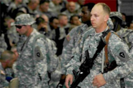 1st Lt. Eric Ladd, commander of the Camp Robinson based 449th Aviation Intermediate Maintenance Company of the 77th Aviation Brigade, prepares his troops to be manifested for a flight to Iraq yesterday. Ladd, of Benton, initially mobilized with his unit on Valentine's Day in support of Operation Iraqi Freedom. The unit departed Fort Hood, Texas, on Sunday, August 20, after completing its initial mobilization training. Ladd's unit is deploying with the Texas National Guard's 36th Combat Aviation Brigade and will be responsible for maintenance of UH-60 Blackhawks, CH-47 Chinooks and AH-64 Apache helicopters in the Iraqi theatre of operations. (Photo by )