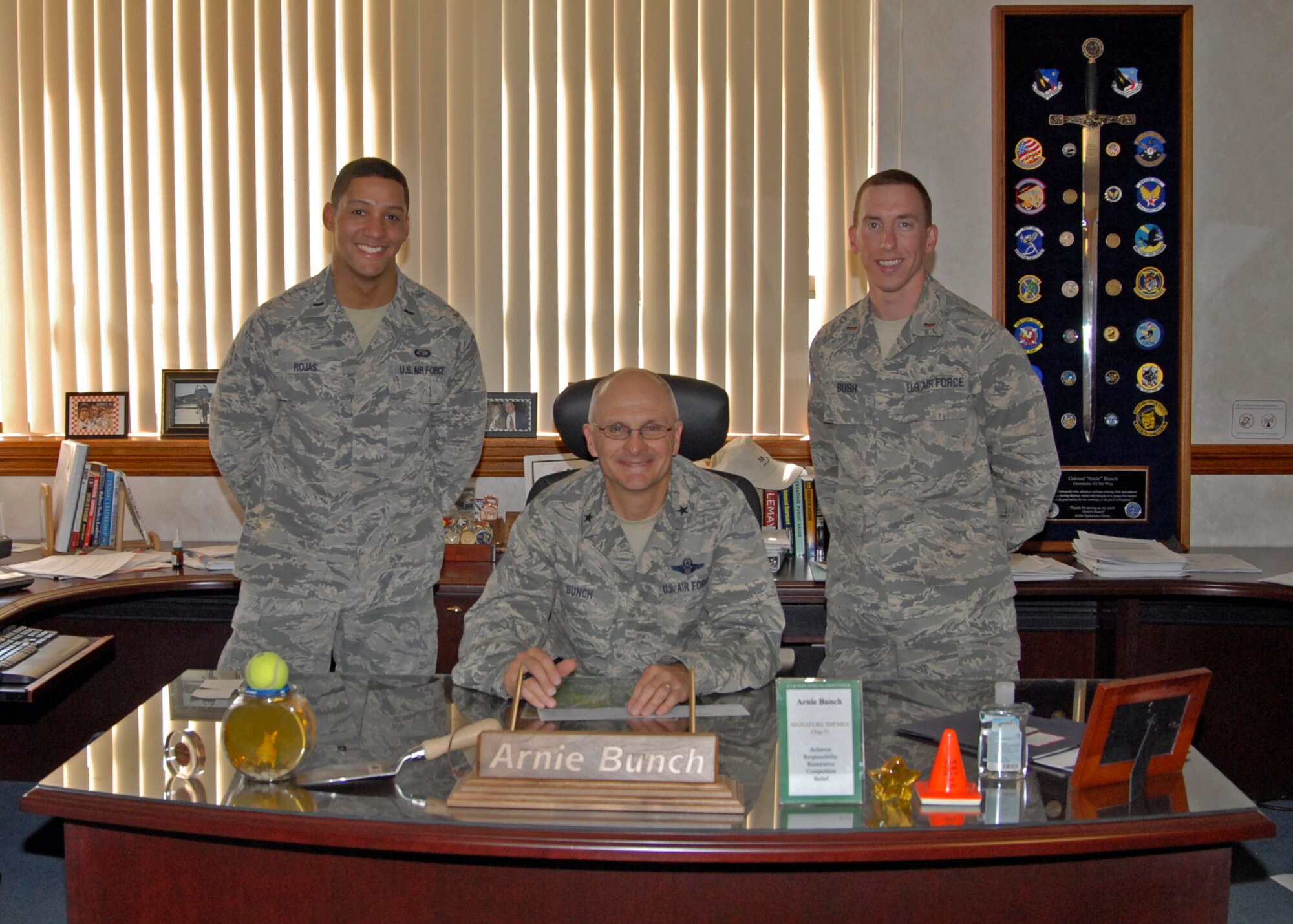 1st Lt. Carlos Rojas, the AFAF installation project officer from the 772nd Test Squadron and 2nd Lt. Ryan Bush, the assistant IPO, from the 411th Flight Test Squadron met with Brig. Gen. Arnold W. Bunch, Air Force Test Center commander when he completed his 2013 Air Force Assistance Fund contribution form. (U.S. Air Force Photo by Laura Mowry)