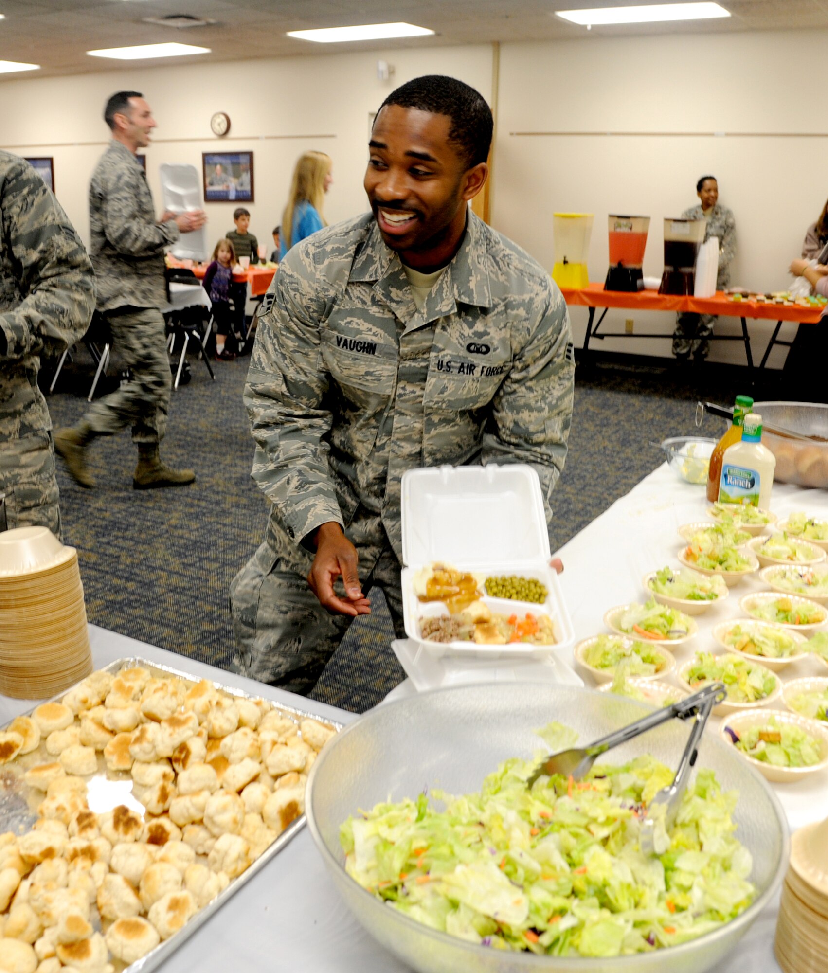 Senior Airman Nate Vaughn, an air traffic controller with the 71st Operational Support Squadron, goes through the serving line at the Singles’ International Gourmet Meal Opportunity March 25 in the Community Chapel Activity Center at Vance Air Force Base, Okla. (U.S. Air Force Photo/ Senior Airman Frank Casciotta)