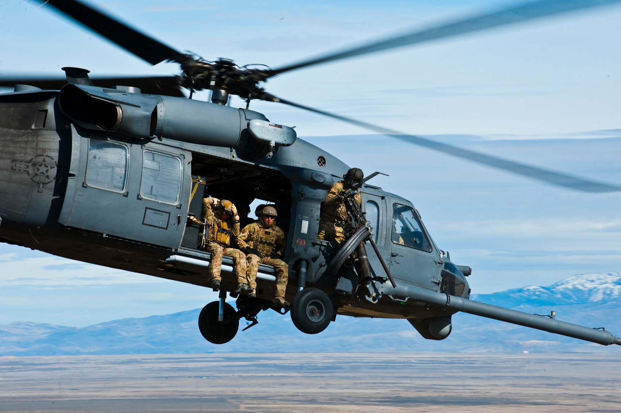 A U.S. Air Force HH-60 Pave Hawk returns to the range during the terminal employment phase March 12, 2013, at the Orchard Combat Training Center, Idaho. The pararescuemen supported the 34th Weapons Squadron in training scenarios during the phase. The "T.E." mission objective is to demonstrate and instruct HH-60 Pave Hawk weapons employment and landing zone options to U.S. Air Force Weapons School students by maximizing weapons proficiency and quickly recover survivors. The phase is one out of a series of advanced training programs administered at the USAF Weapons School located at Nellis Air Force Base, Nev. (U.S. Air Force photo by Senior Airman Brett Clashman)