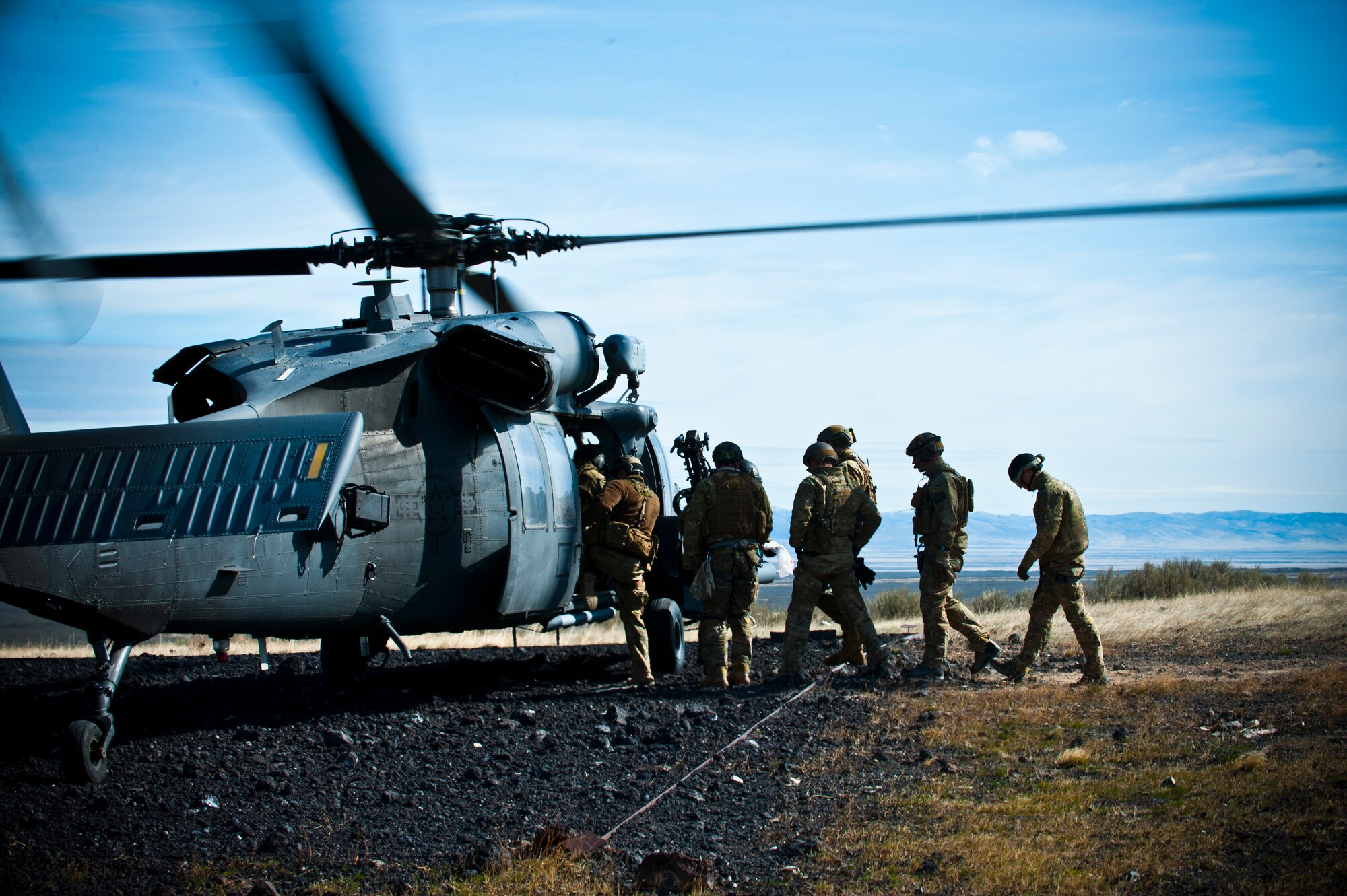 U.S. Air Force pararescuemen board an HH-60 Pave Hawk during the terminal employment phase March 12, 2013, at the Orchard Combat Training Center, Idaho. The pararescuemen supported the 34th Weapons Squadron in training scenarios during the phase.  The "T.E." mission objective is to demonstrate and instruct HH-60 Pave Hawk weapons employment and landing zone options to U.S. Air Force Weapons School students by maximizing weapons proficiency and quickly recover survivors. The phase is one out of a series of advanced training programs administered at the USAF Weapons School located at Nellis Air Force Base, Nev. (U.S. Air Force photo by Senior Airman Brett Clashman)