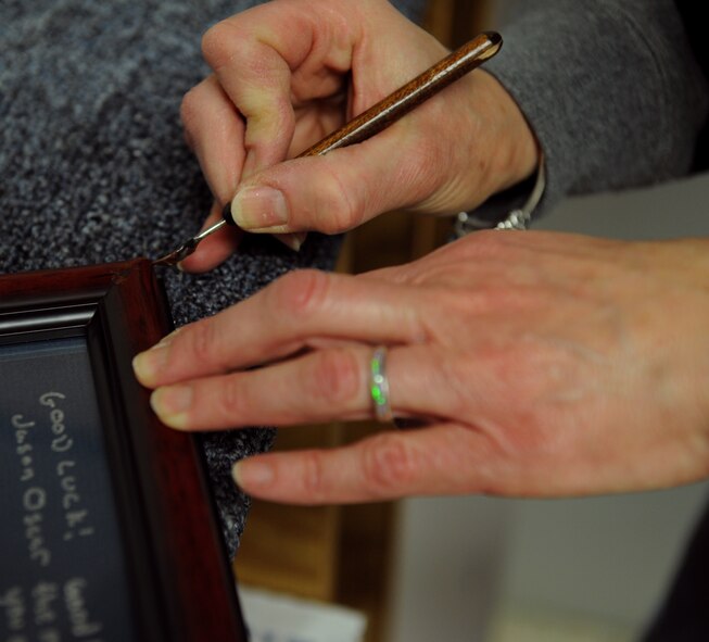 Brenda Porter, Arts and Crafts frame shop, fills in the open space on the corner of a frame on Barksdale Air Force Base, La., March 27. The frame shop works on more than 20 projects a week. (U.S. Air Force photo/Airman 1st Class Benjamin Gonsier)