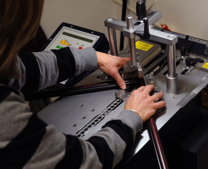 Brenda Porter, Arts and Crafts frame shop, uses a V-Nailer to assemble a frame on Barksdale Air Force Base, La., March 27. The frame shop is open Monday to Friday from 9 a.m. to 5 p.m. (U.S. Air Force photo/Airman 1st Class Benjamin Gonsier)