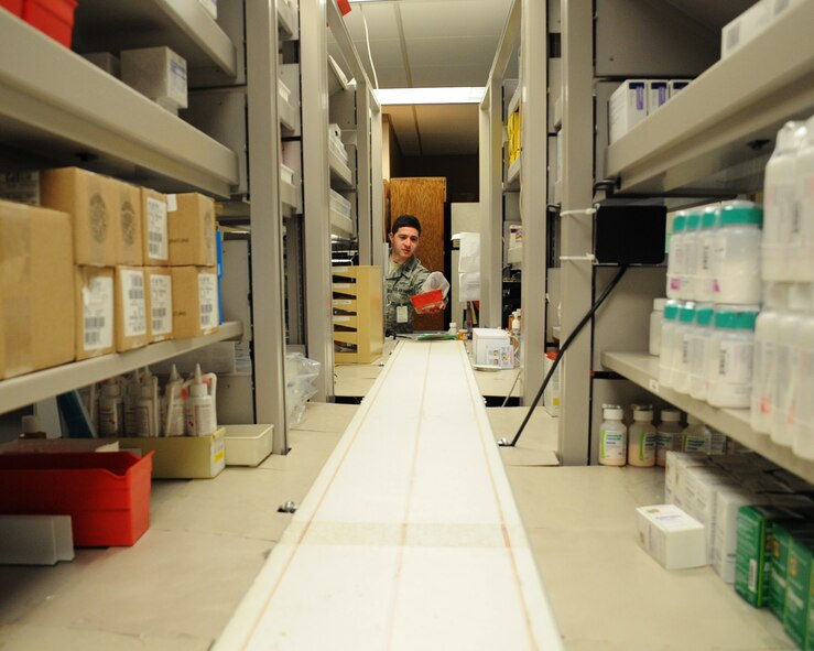 Capt. Aleksey Ushkin, 2nd Medical Support Squadron clinic pharmacist operations element chief, sends a patient's prescriptions to the checkout counter at the main pharmacy on Barksdale Air Force Base, La., March 27. The main and satellite pharmacies process more than 5,000 prescriptions each week. (U.S. Air Force photo/Senior Airman Sean Martin)