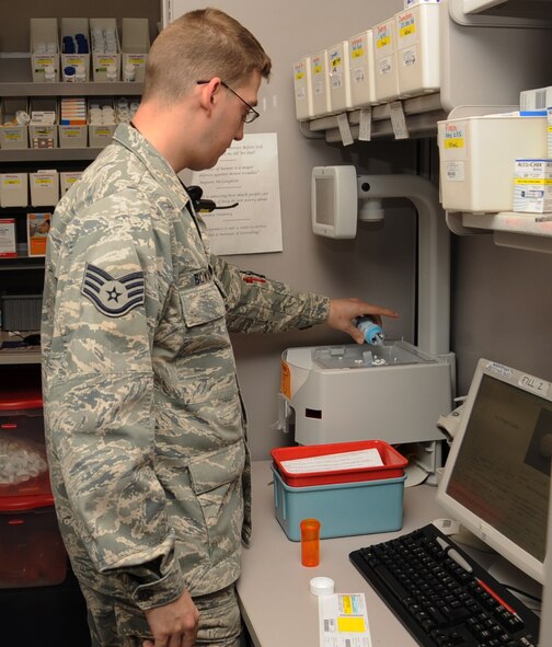 Staff Sgt. Zach Bowling, 2nd Medical Support Squadron narcotic custodian, uses an Eyecon machine to count a patients medication at the main pharmacy on Barksdale Air Force Base, La., March 27.  The machine allows a pharmacist to get a faster count of a patient's medication eliminating the overall wait time. (U.S. Air Force photo/Senior Airman Sean Martin)