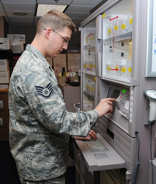 Staff Sgt. Zach Bowling, 2nd Medical Support Squadron narcotic custodian, looks for a prescription on Barksdale Air Force Base, La., March 27. Controlled substances are stored in a secure locker which can only be accessed by pharmacy technicians. (U.S. Air Force photo/Senior Airman Sean Martin)