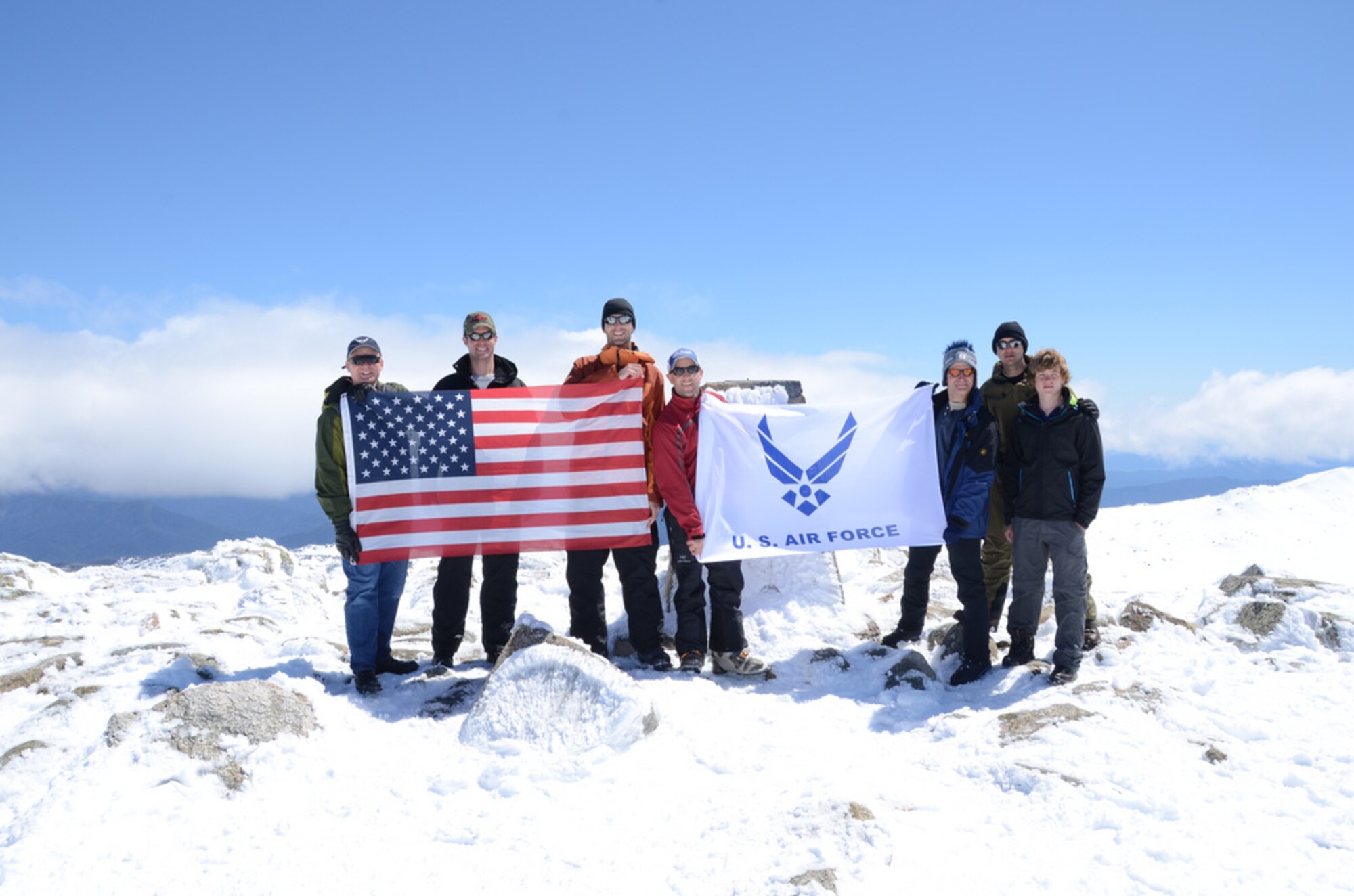 Members of the US Air Force hold the American and United States Air Force flag at the top of Mt. Kosciuszko, the highest peak on the Australian continent in 2011. Mount Kosciuszko is the sixth peak of their 'USAF 7 Summits Challenge'. The team of Airmen will attempt to climb Mount Everest in April 2013. (Courtesy photo) 
