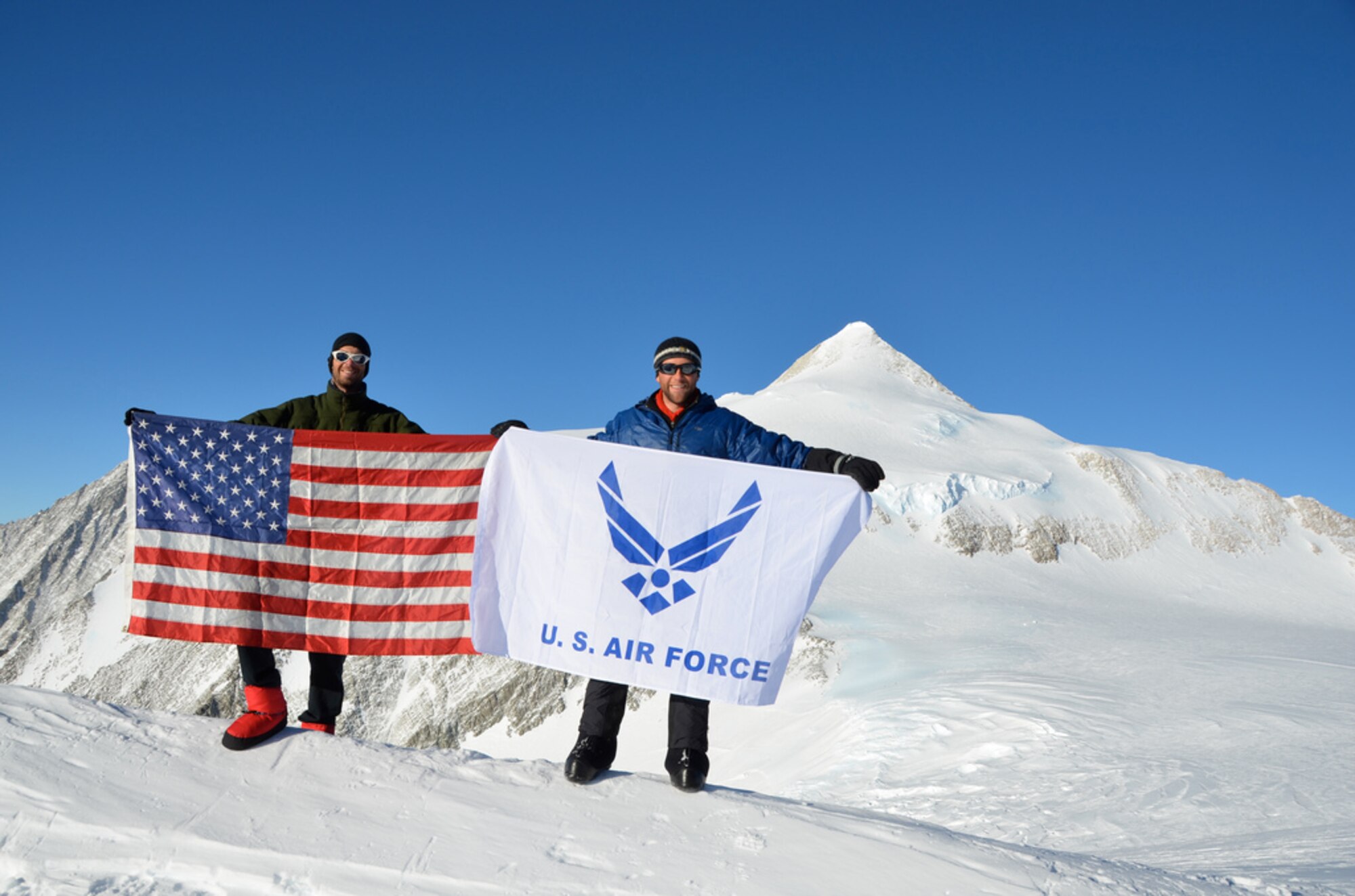 Members of the USAF 7 Summits Challenge Team hold the American and Air Force flags at of Antarctica’s highest mountain Mount Vinson in 2010. The team of Airmen will attempt to climb Mount Everest in April 2013. (Courtesy photo) 
