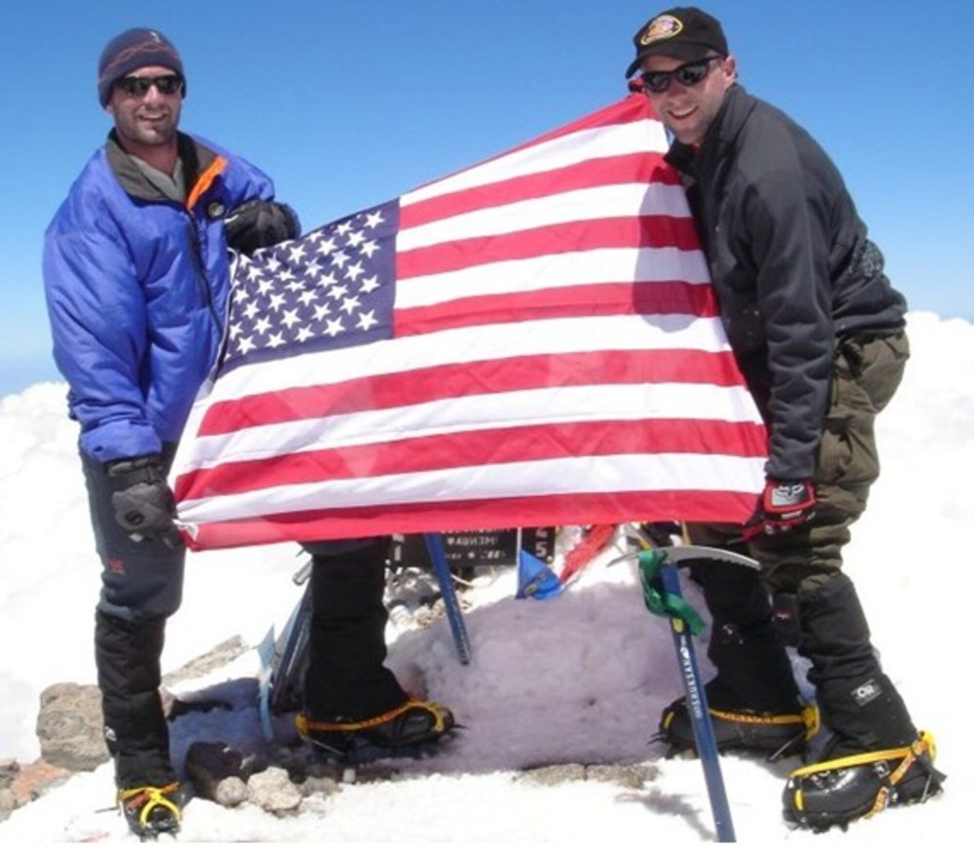 Then Capt. Rob Marshall and 1Lt. Mark Uberuaga pose with the American Flag at the top of Mount Elbrus, Europe in 2005. The first-summit climb was self-guided and in memory of the fallen Air Commandos aboard the USAF MC-130H, Call-sign "Wrath 11", lost in Albania earlier that year. The team of Airmen will attempt to climb Mount Everest in April 2013. (Courtesy photo)